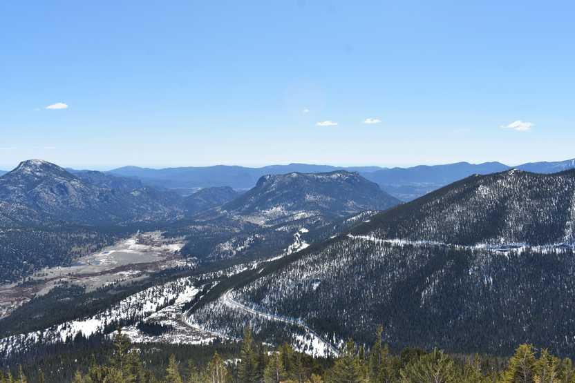 A valley surrounded by some mountains. You can see some roads built along the edge of the mountains.