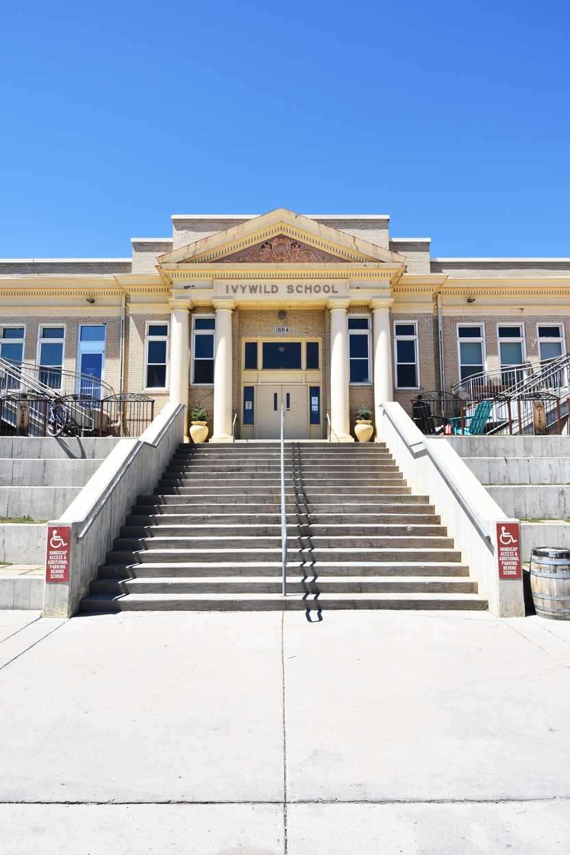 The exterior of Ivywild School. There are several steps leading up to a double door entrance.