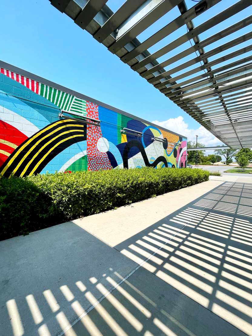 A colorful, abstract mural outside at the 8th Street Market.