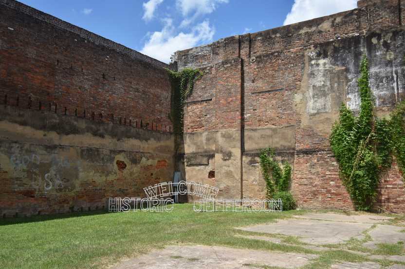 The corner of some old buildings with a green lawn in front of them. A light up sign reads "Welcome Historic Jefferson" The corner of some old buildings with a green lawn in front of them. A light up sign reads "Welcome Historic Jefferson"