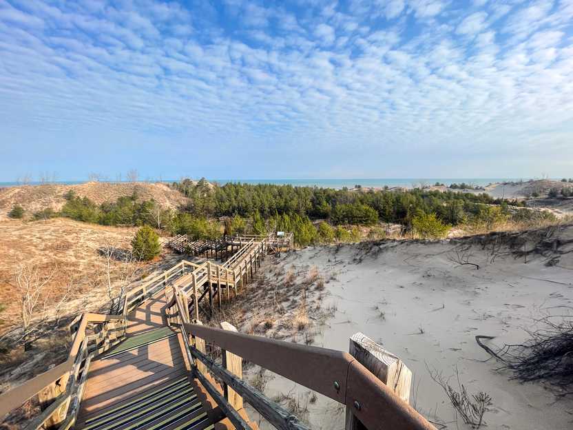 Wooden steps built over sand dunes next to Lake Michigan.