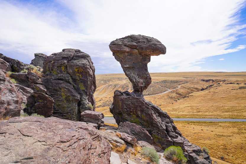 A large rock balancing on a very thin area.
