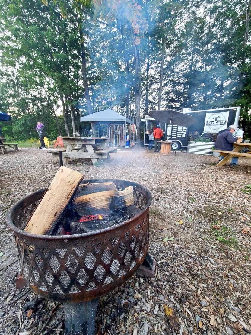 A fire pit outside of the food truck StrEatz