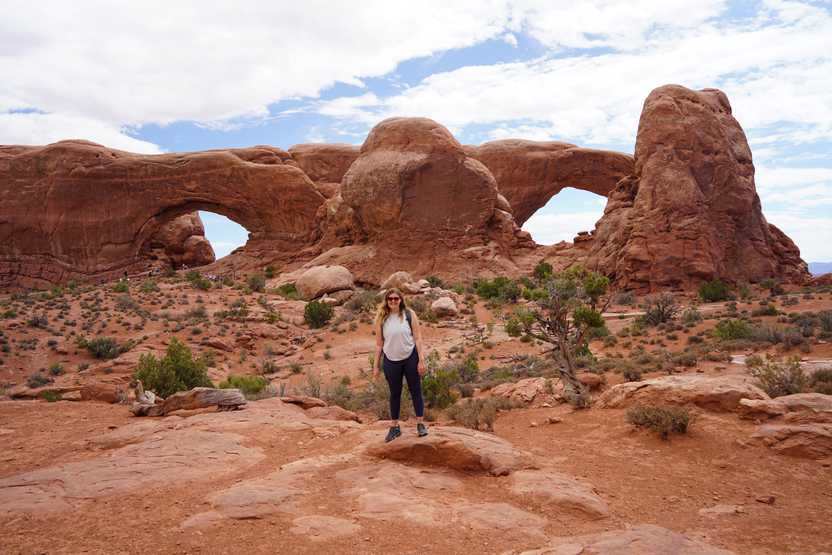 Lydia standing centered between the Windows, two giant arches that resemble the shape of eyes.