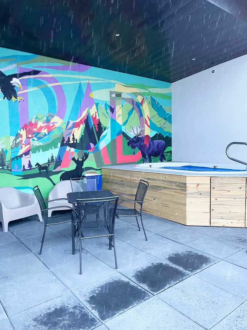 The hot tub at The Pad. There is a colorful mural behind the hot tub that says The Pad and has moose, an eagle and other wildlife in a mountain scene. The hot tub at The Pad. There is a colorful mural behind the hot tub that says The Pad and has moose, an eagle and other wildlife in a mountain scene.