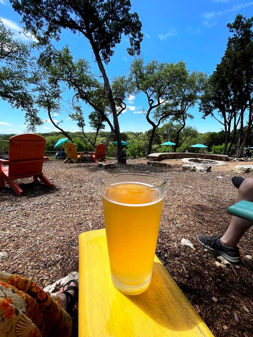 A glass of light-colored beer sitting on a yellow lawn chair at Shady Llama. A glass of light-colored beer sitting on a yellow lawn chair at Shady Llama.