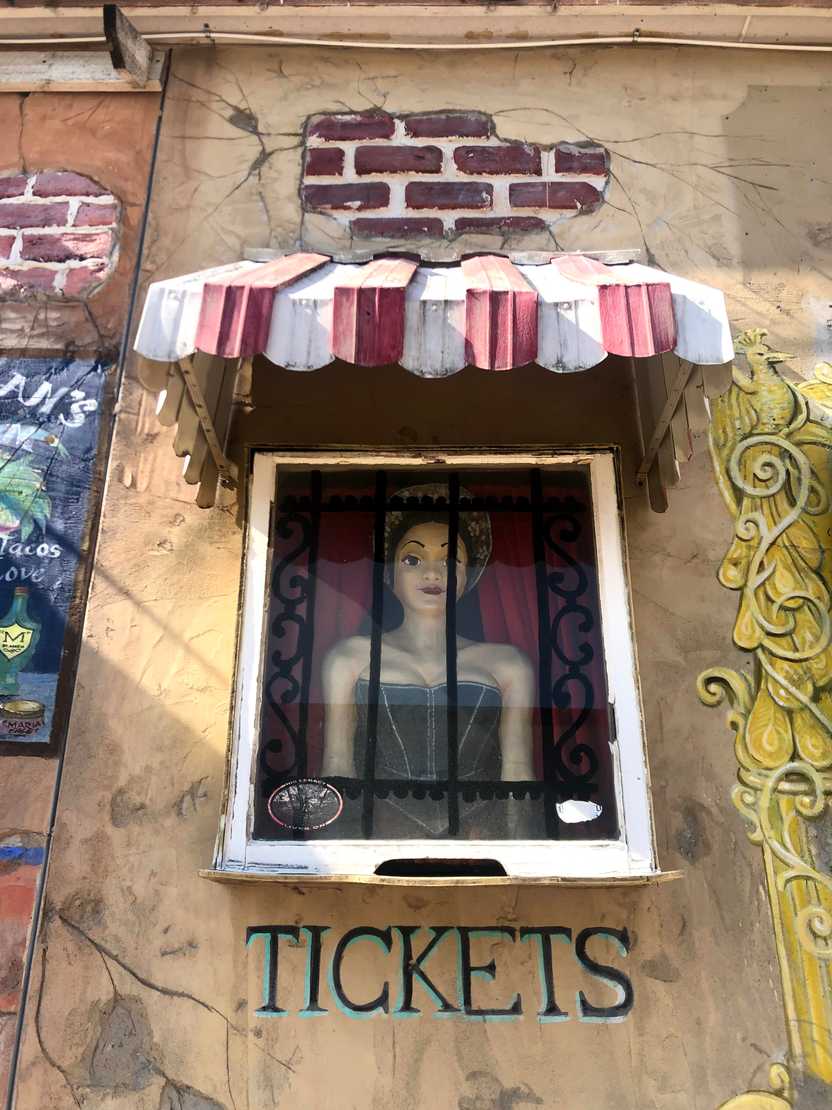 Artwork of a woman behind bars at Maria's.