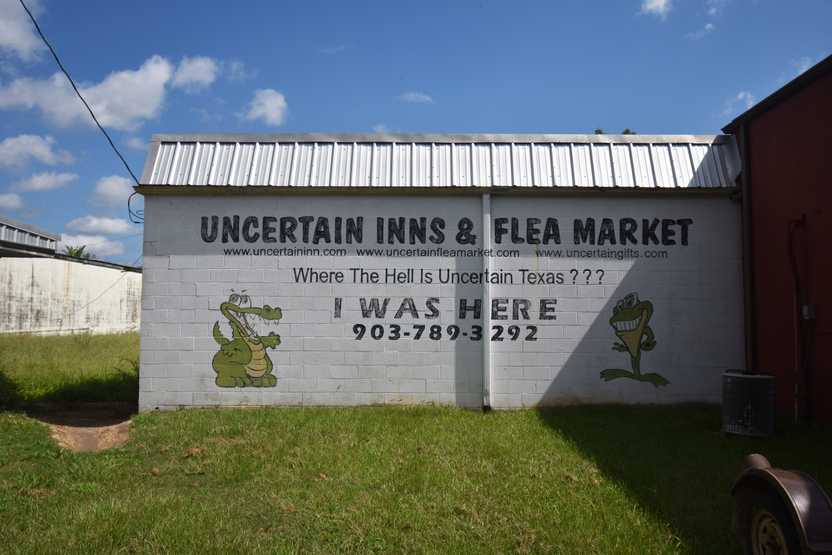 A mural reading "Uncertain Inns and Flea Market," "Where the hell is Uncertain, Texas???" and "I was here" A mural reading "Uncertain Inns and Flea Market," "Where the hell is Uncertain, Texas???" and "I was here"