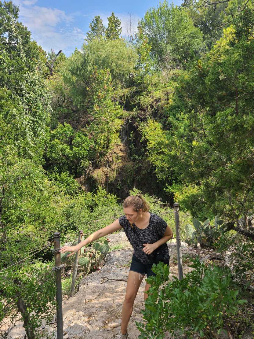 Lydia hiking up the rope portion of the trail that leads to Gorman Falls.