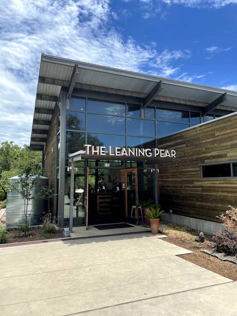 The exterior of The Leaning Pear, which looks modern with a lot of glass windows. The exterior of The Leaning Pear, which looks modern with a lot of glass windows.