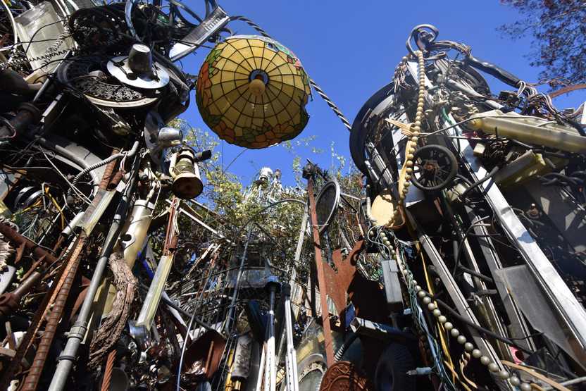 Looking up a light and walls made of found objects at the Cathedral of Junk.