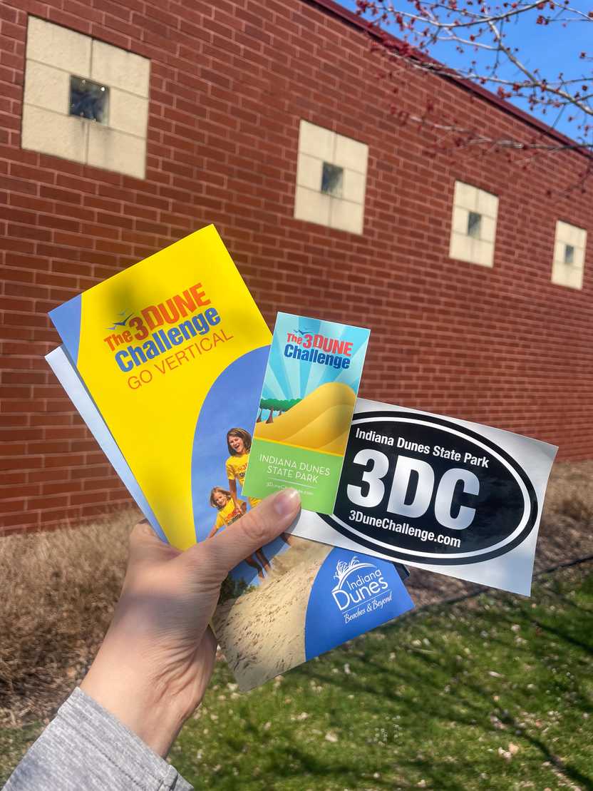 A brochure and stickers that are given up for completing the 3 Dunes Challenge trail in Indiana Dunes State Park.