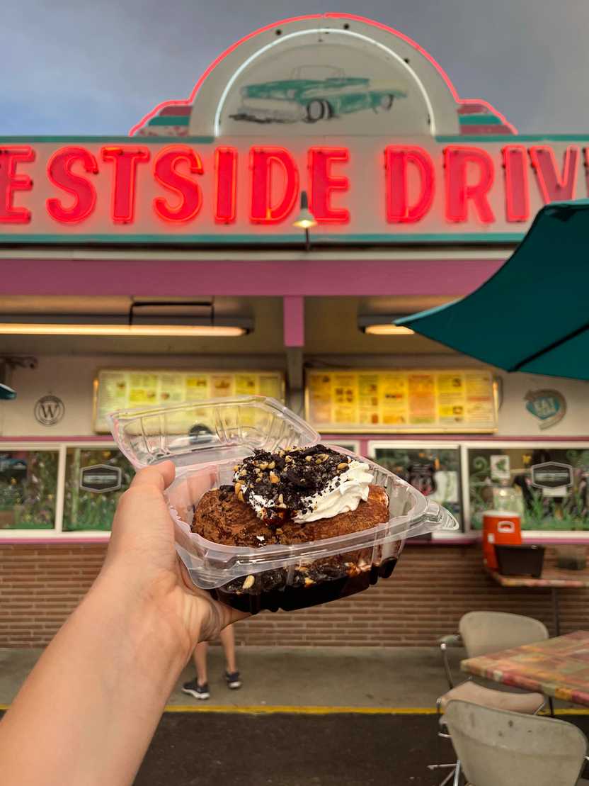 Holding up the baked potato ice cream in front of the West Side Drive in.