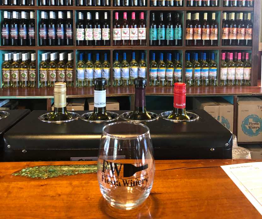 A wine glass sitting at a bar at the Fiesta Winery.