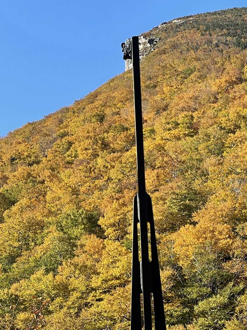 A pole lining up to a cliff to create a face at the Profile Plaza. The pole resembled what the Old Man of the Mountain looked like before the rocks collapsed.