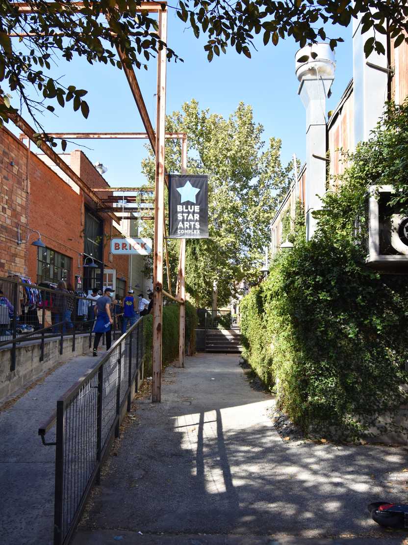 An outdoor area with a sign that reads 'Blue Star Arts Complex'