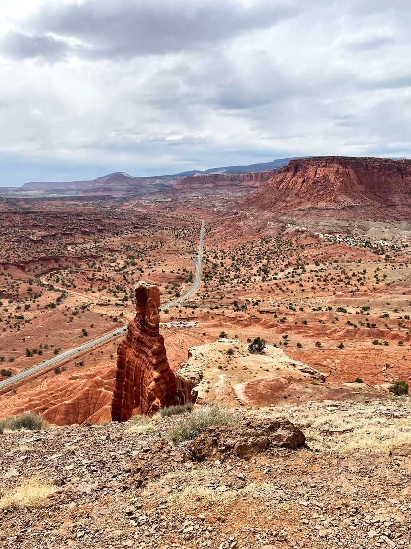 Looking down at the Chimney Rock with a view of the valley and the road below it.
