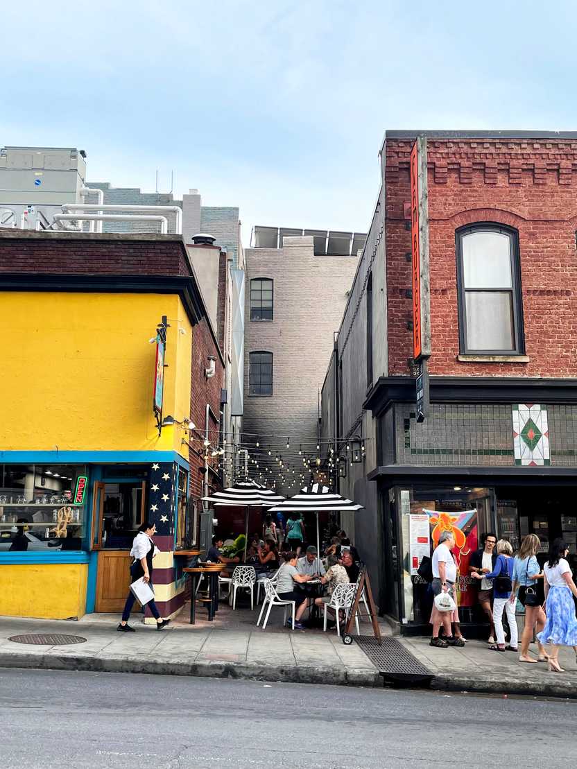 Outdoor seating in between two buildings in Downtown Asheville.