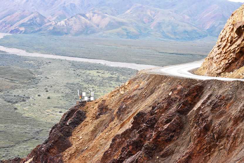 A road winding around the edge of a mountain in Denali National Park.