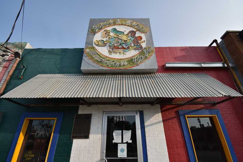 The exterior of Pepe & Mito's. The building is painted red, white and green.