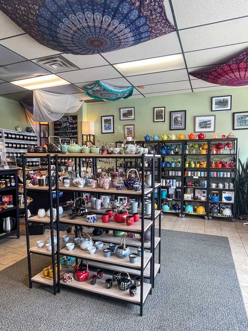 A room with shelves full of teapots and vases in Spice of Life Tea Shop A room with shelves full of teapots and vases in Spice of Life Tea Shop