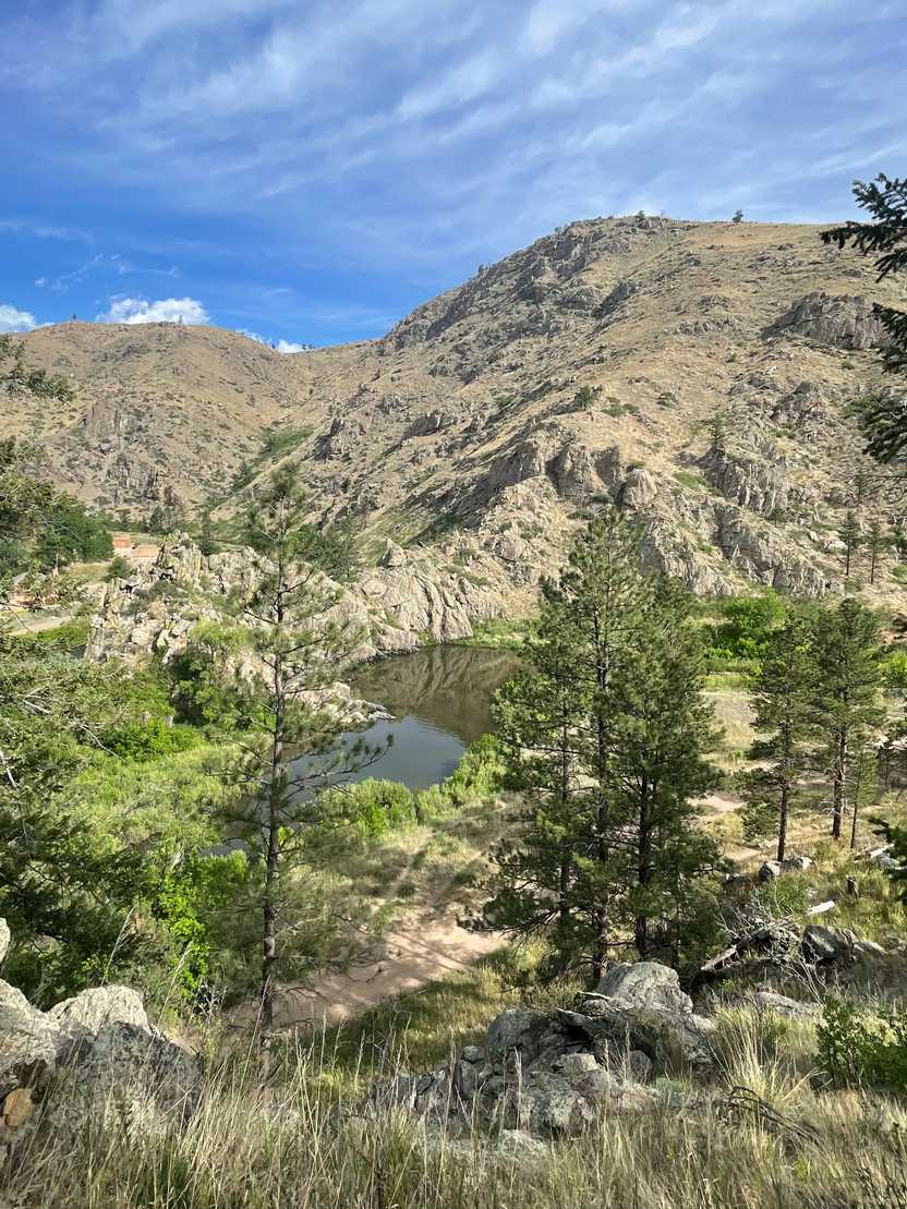 A view of a river, a mountain and green trees in the Gateway Natural Area.