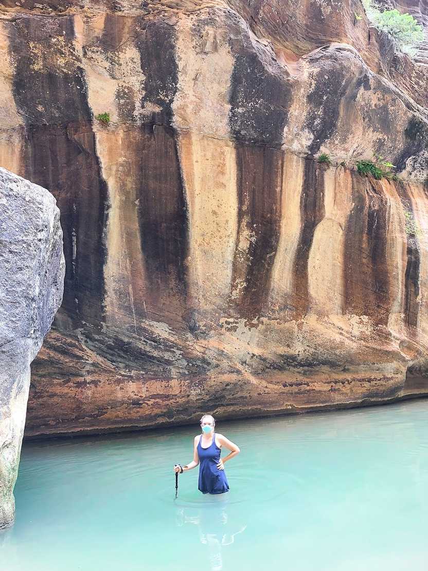 Lydia standing waist deep in the water on The Narrows trail in Zion National Park. Lydia standing waist deep in the water on The Narrows trail in Zion National Park.