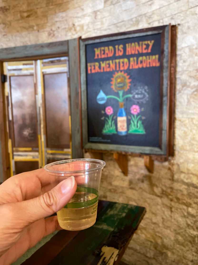 Holding up a mead sample in the Savnnah Bee Company