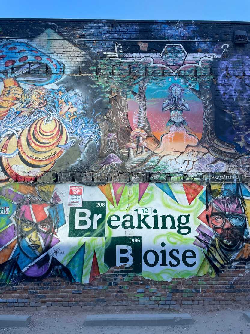 A wall covered in murals, including a piece of art that reads "Breaking Boise" and resembles the "Breaking Bad" logo A wall covered in murals, including a piece of art that reads "Breaking Boise" and resembles the "Breaking Bad" logo
