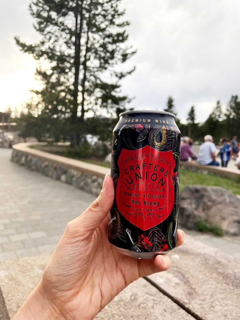 Holding up a can of beer outside of Canyon Eatery