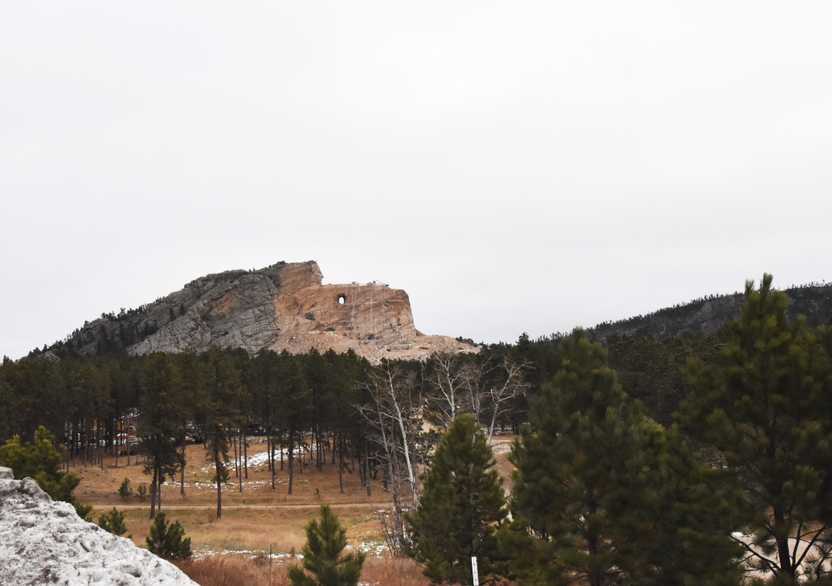 A rock carving of an Oglala Lakota warrior carved into a huge rock face.