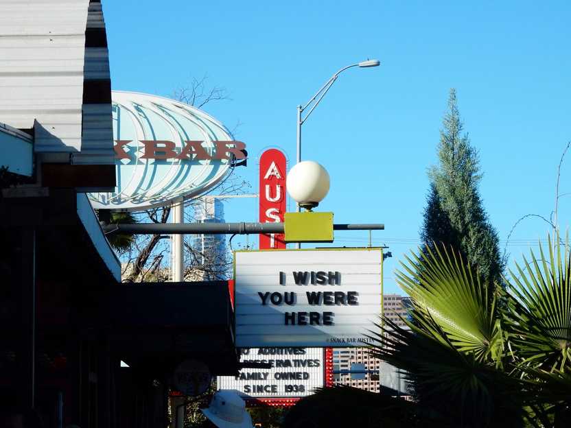 Signs on South Congress Avenue in Austin. One reads "I Wish You Were Here"