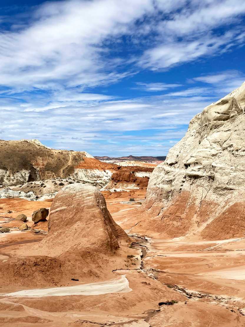 A view of rocks with swirling orange and white colors on the Toadstool Hoodoos hike. A view of rocks with swirling orange and white colors on the Toadstool Hoodoos hike.