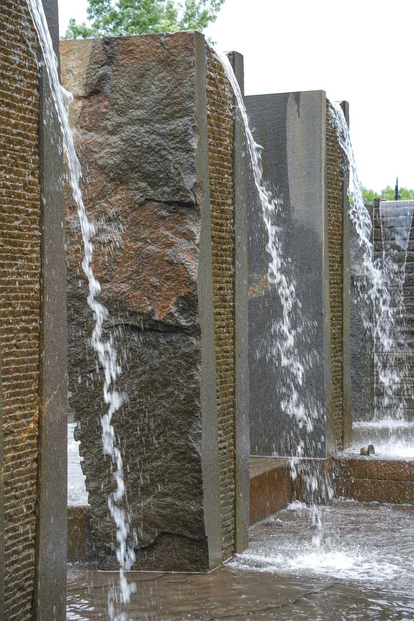 Water falling from a stone wall at the Granite Fountain along Lake George Water falling from a stone wall at the Granite Fountain along Lake George