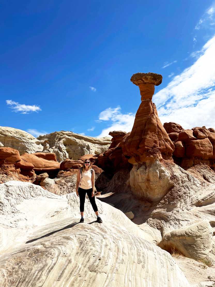 Lydia standing with hoodoos behind her. Lydia standing with hoodoos behind her.