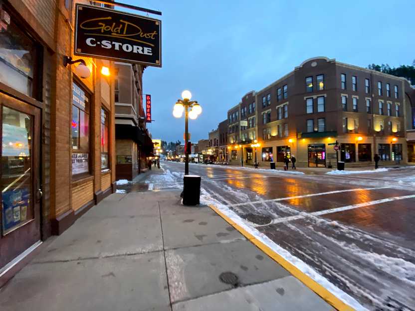 A street in the city of Deadwood. A sign reads 'Gold Dust C-Store'