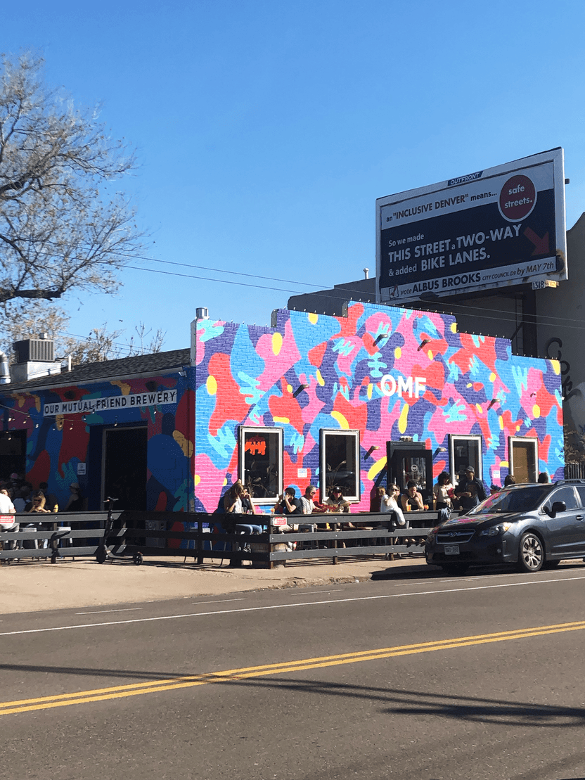 The exterior of Our Mutual Friend Brewery, which is very colorful and painted in an abstract design.