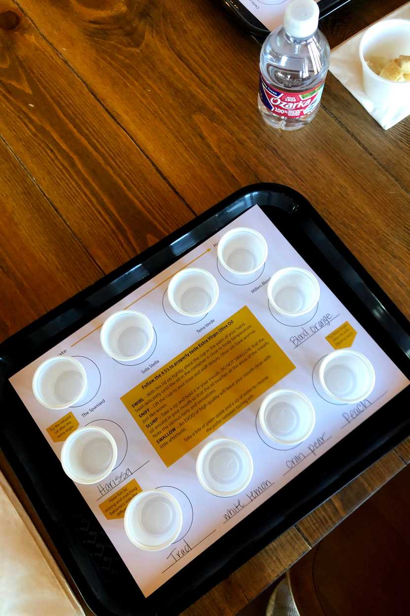 A tray of 10 plastic cups for olive oil samples.
