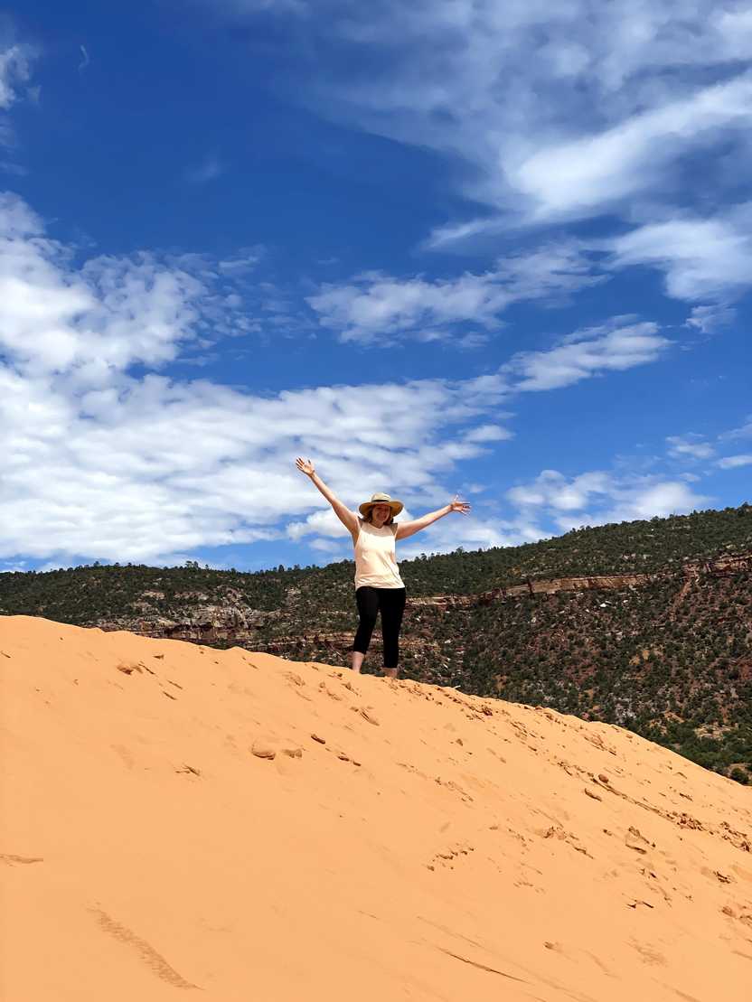 Lydia on top of a sand dune at Coral Pink Sand Dunes State Park. Lydia on top of a sand dune at Coral Pink Sand Dunes State Park.