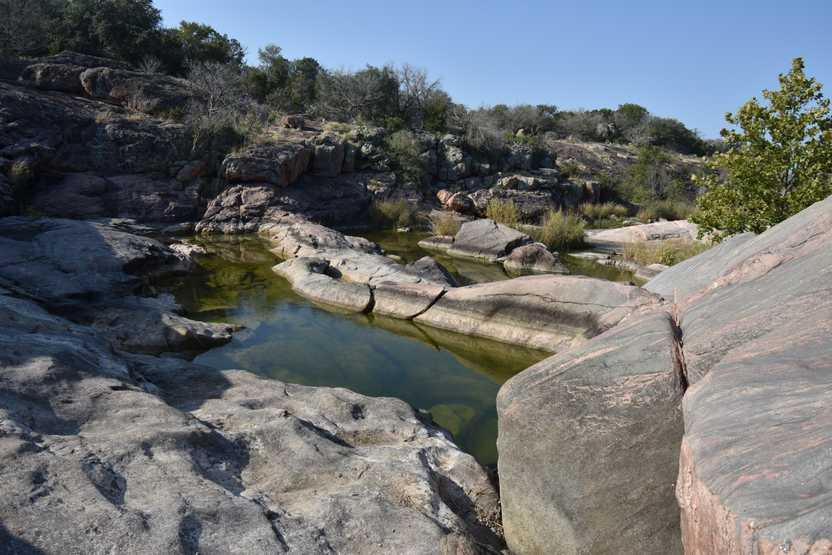 Several pools of water on the Valley Spring Creek trail in Inks Lake State Park.