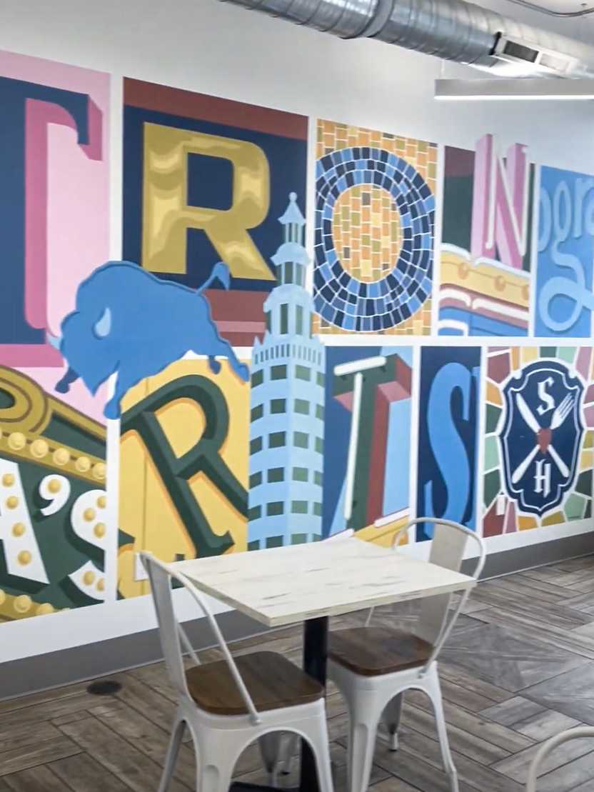 A colorful wall that reads 'Strong Hearts' in abstract letters.