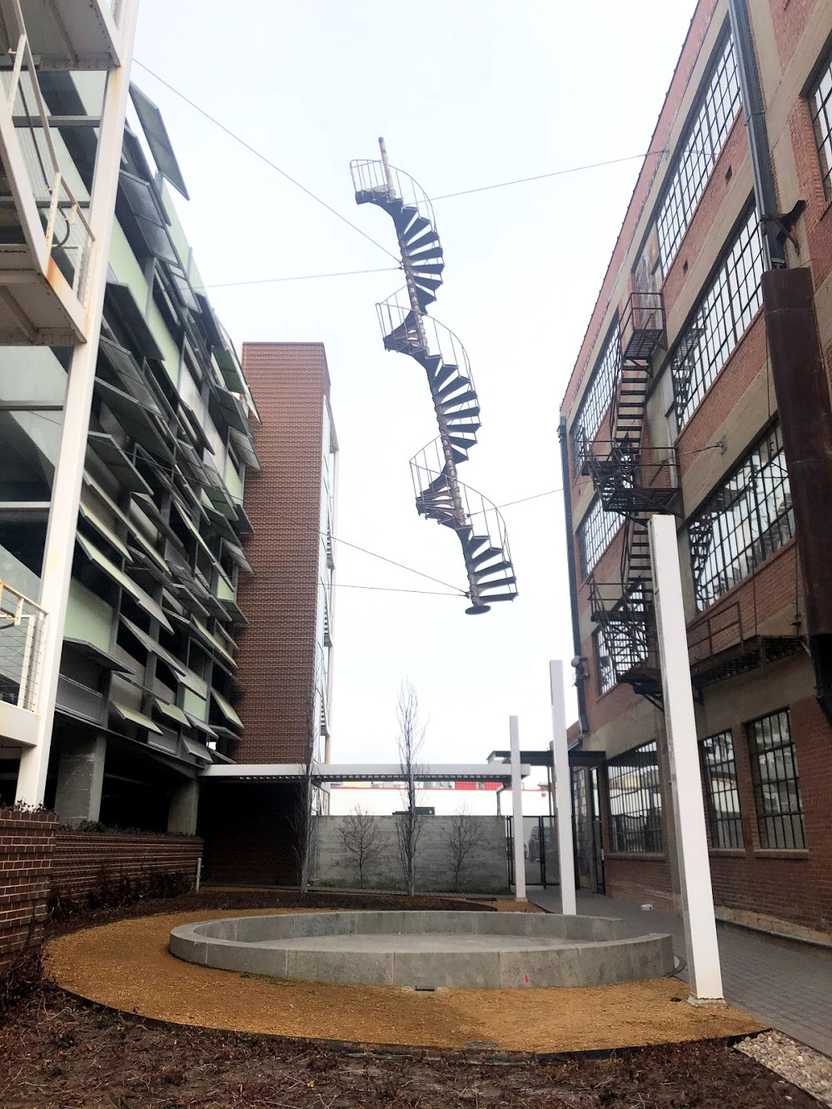An alley with a hanging spiral staircase that resembled a DNA strand.