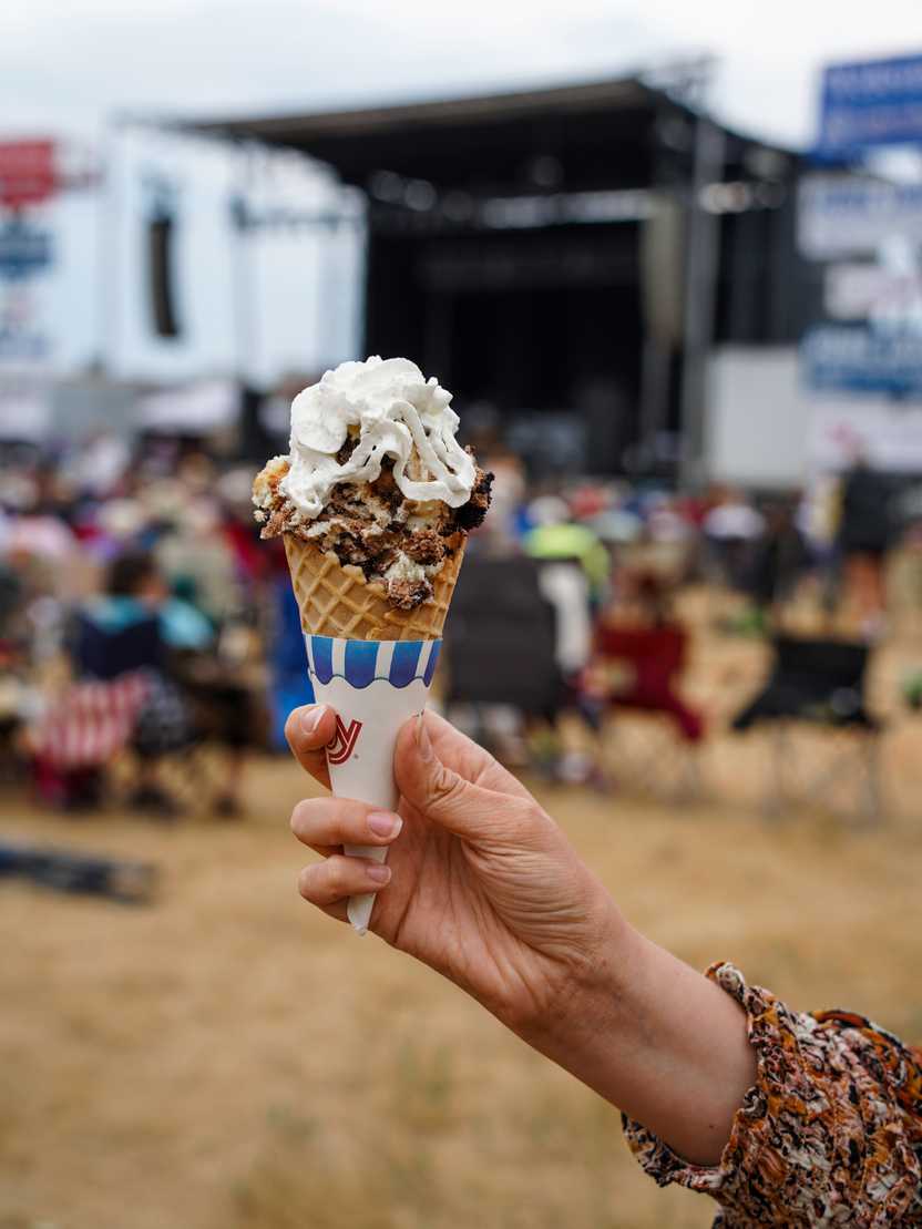 Cheesecake in a waffle cone topped with whipped cream.