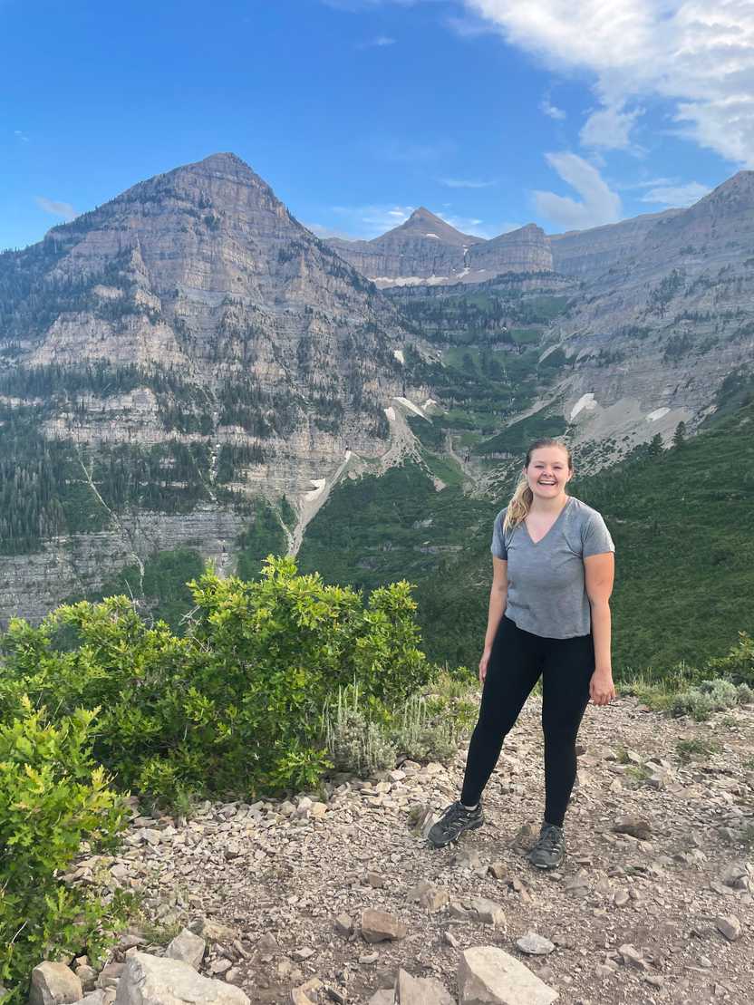 Lydia standing in front of the mountain view on Primrose Overlook.