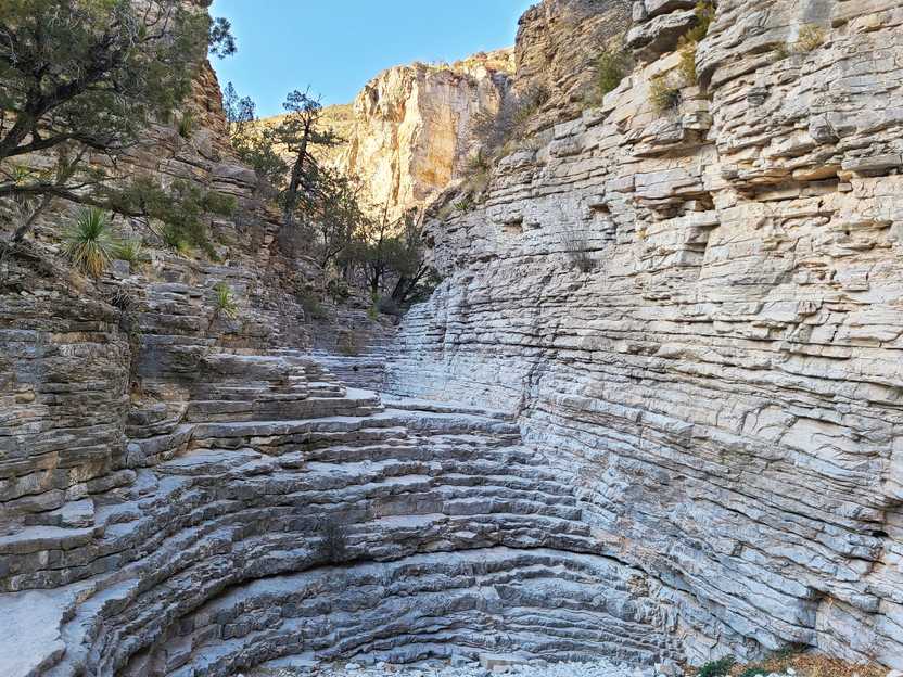 A wall of rocks that are stacks in such a way that it creates a natural staircase.