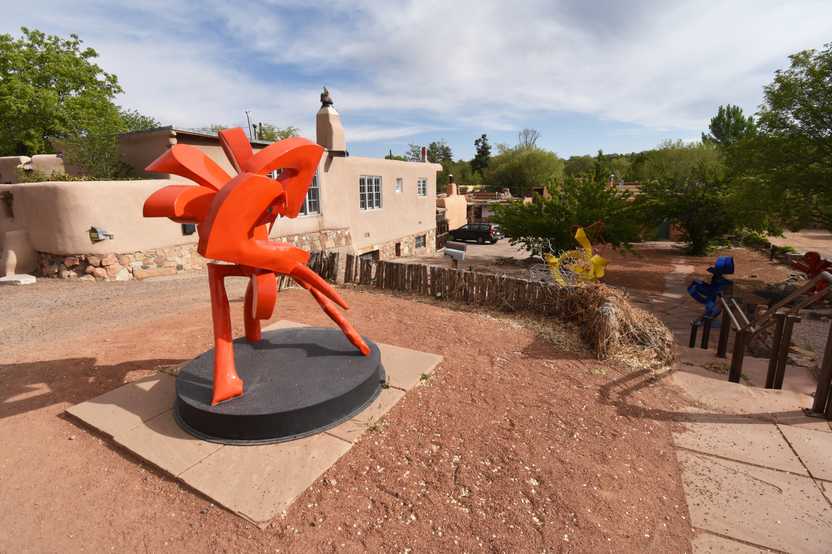 An organically shaped, red sculpture along Canyon Road.