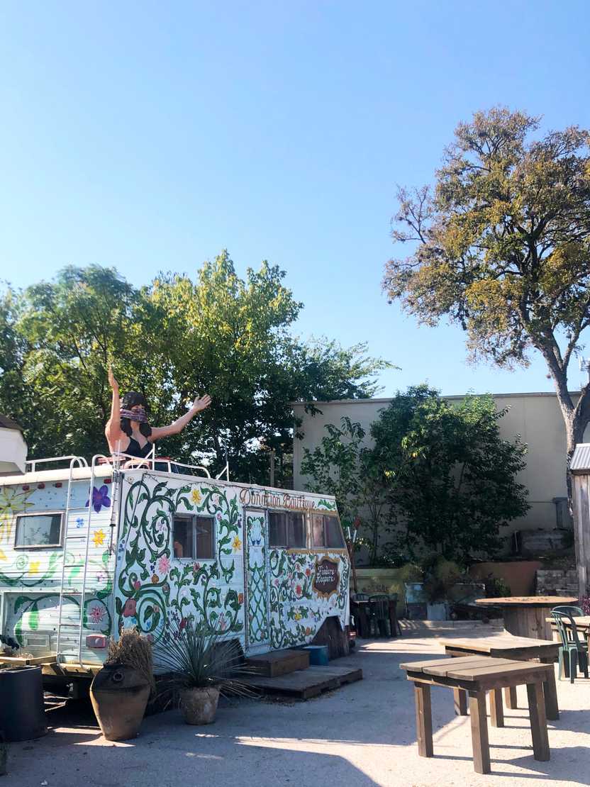 A white bus painted with vines at Maria's Taco Xpress.