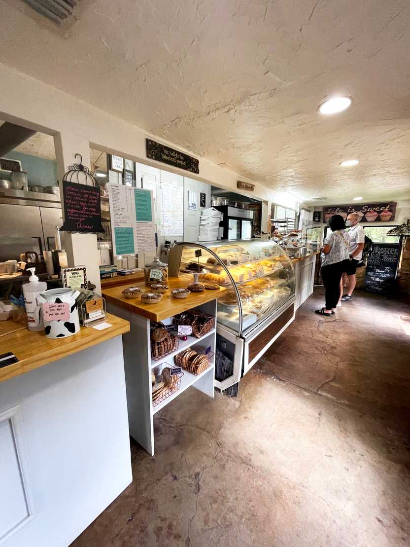 The inside of Sugar Shack Bakery, where there is a display case full of pastries. The inside of Sugar Shack Bakery, where there is a display case full of pastries.