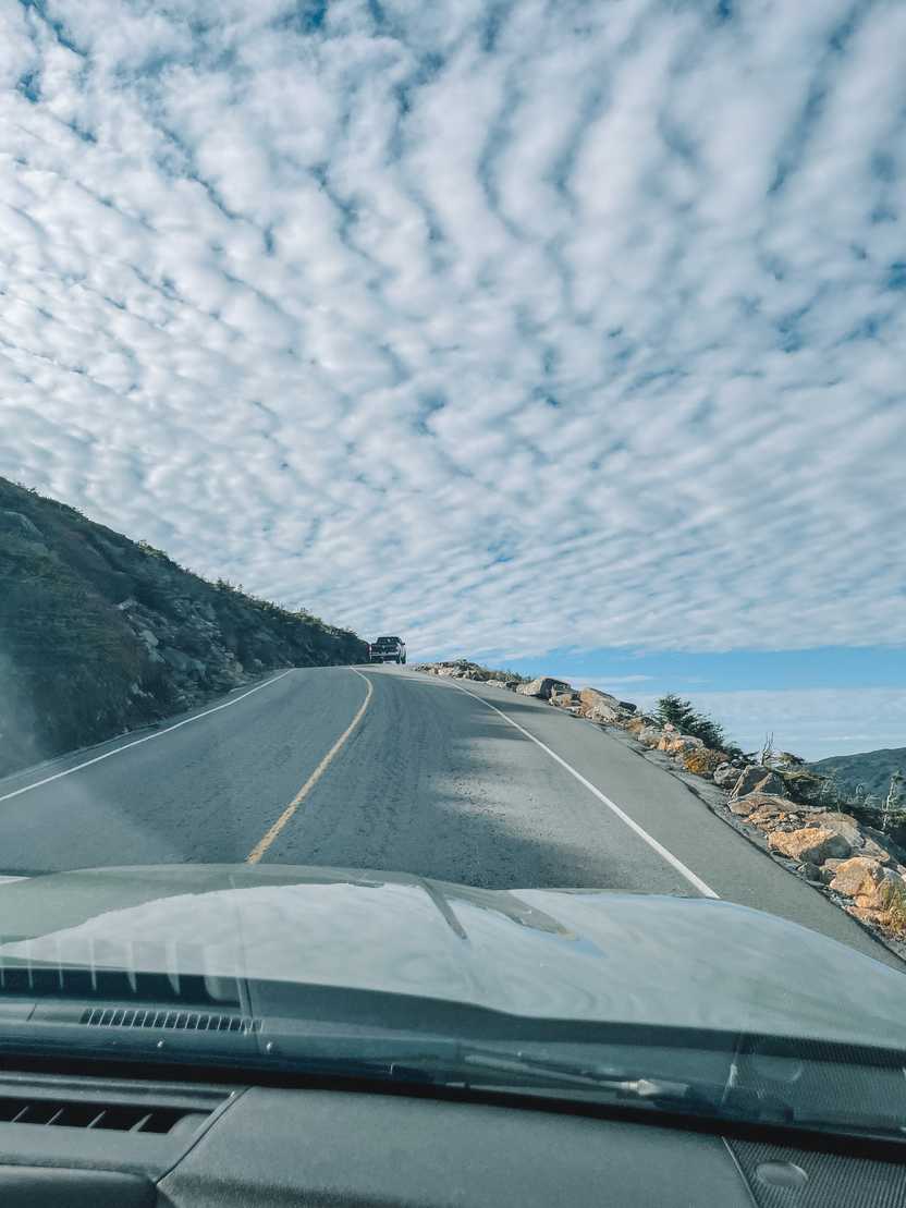 Driving up a road with a steep drop off on one side.