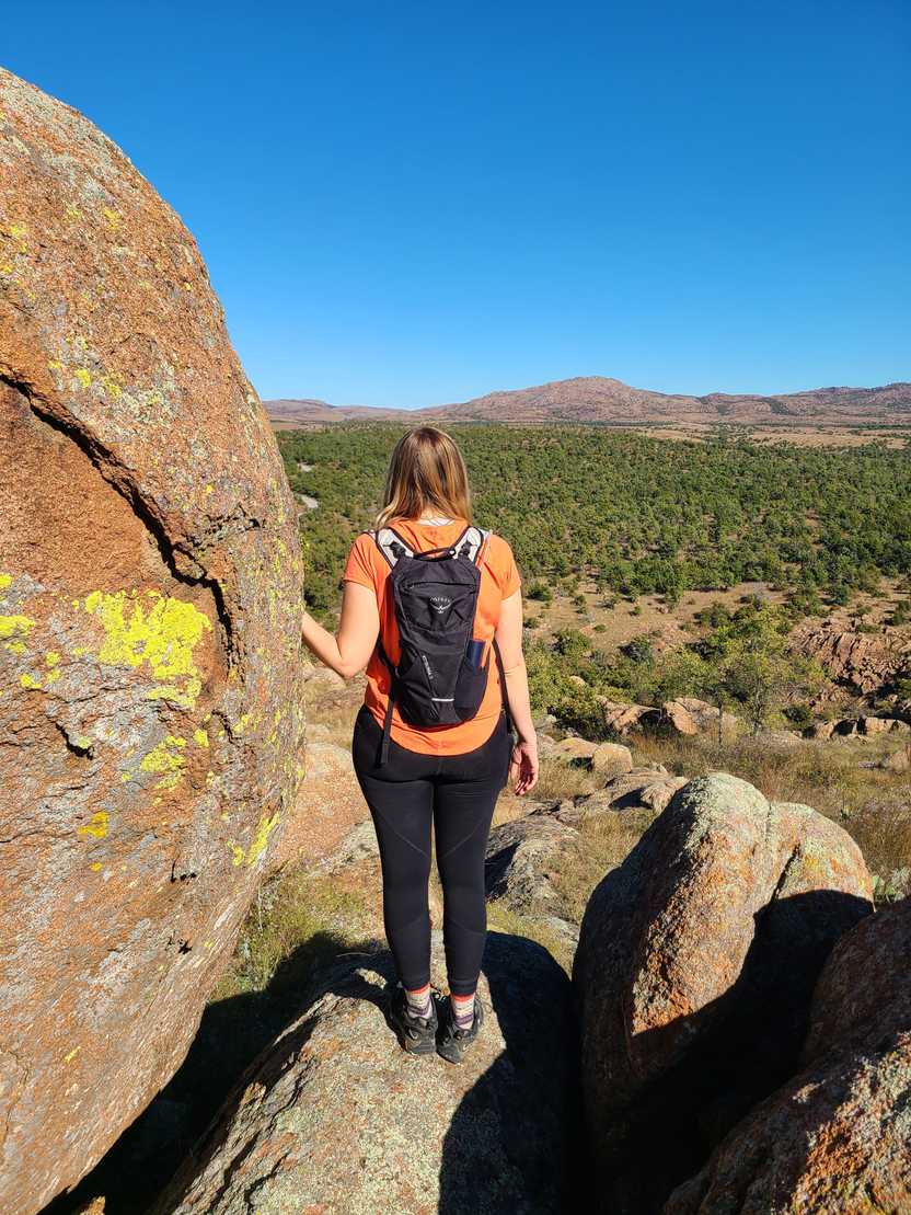 Lydia with her back to the camera looking out at a view on a trail in the Wichita Mountains, Oklahoma. Lydia with her back to the camera looking out at a view on a trail in the Wichita Mountains, Oklahoma.